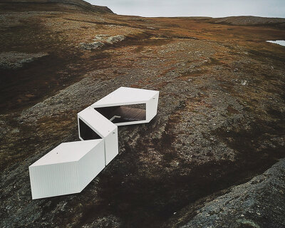 a timber-clad viewpoint designed by biotope opens in norway's arctic landscape