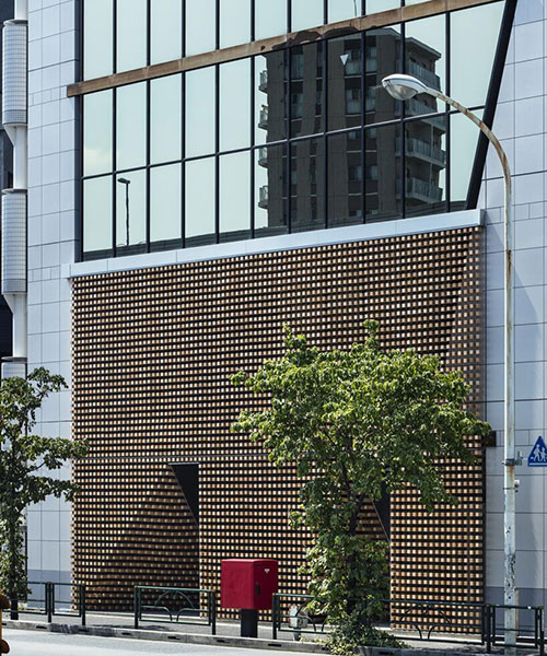 tsukagoshi miyashita sekkei arranges wooden blocks into 'lumber curtain' facade in tokyo
