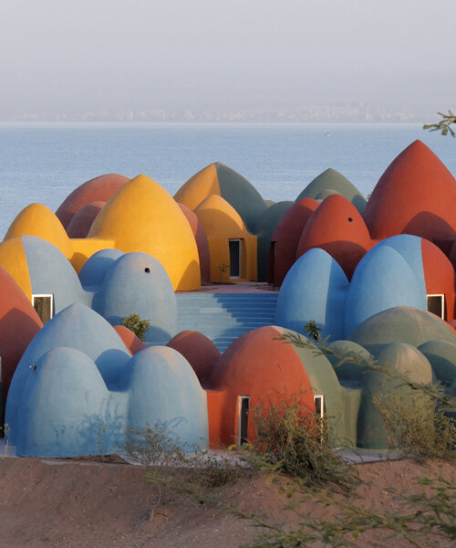 ZAV architects builds colorful village of rammed earth domes on iran's hormuz island