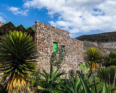 'casa georgina' by departamento del distrito sits within stonewalled garden in mexico