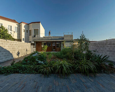 concrete volumes enclose private patio within 'sobreira pires' house by daniel pires in portugal