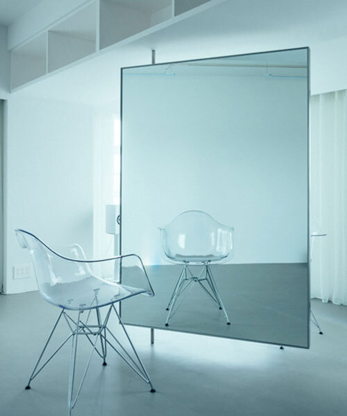 large floating mirror captures urban views within private salon by 2nf+ in tokyo