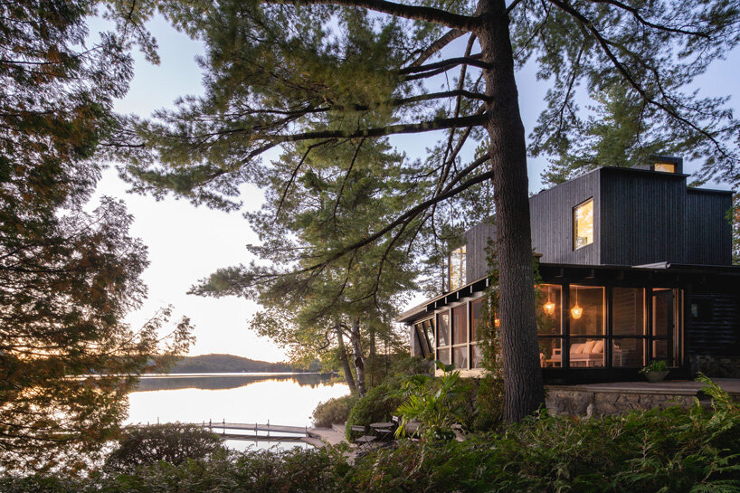 paul bernier architecte tops rustic log cabin in canada with monolithic wood-clad extension