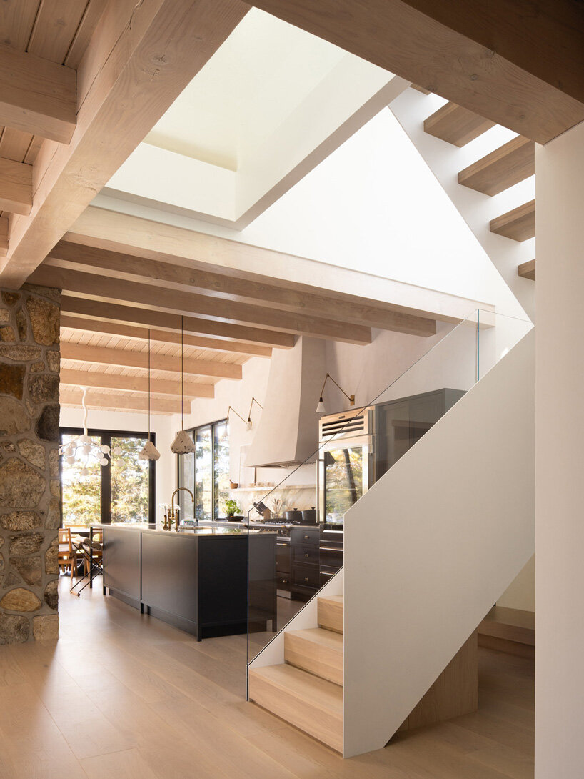 paul bernier architecte tops rustic log cabin in canada with monolithic wood-clad extension