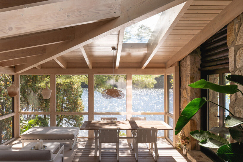 paul bernier architecte tops rustic log cabin in canada with monolithic wood-clad extension