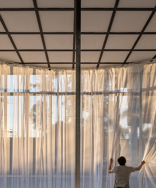sher maker wraps billowing curtains around a multifunctional space in chiangmai