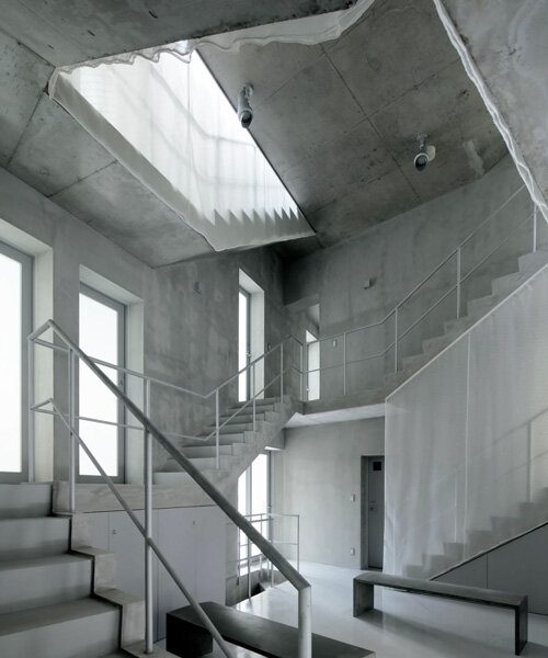 two concrete spiral staircases define TA+A's 'tokyo gasshuku-jo' share house
