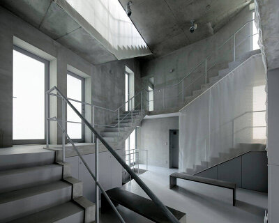 two concrete spiral staircases define TA+A's 'tokyo gasshuku-jo' share house