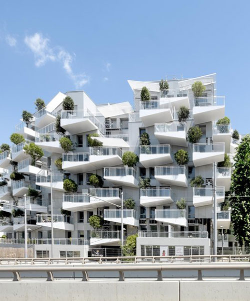 triangular white balconies protrude from valode & pistre's housing complex in france