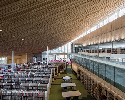 MIKAMI architects tops tonami public library with a giant wooden roof