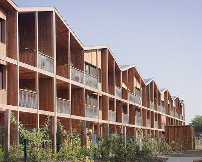 TANK's wooden residential building in nantes exists between urban + rural landscapes