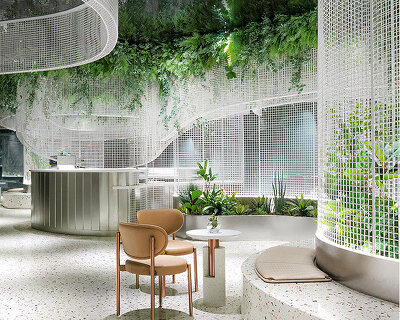 karv one installs flowy metal ceiling fixture within dreamy café interior in china