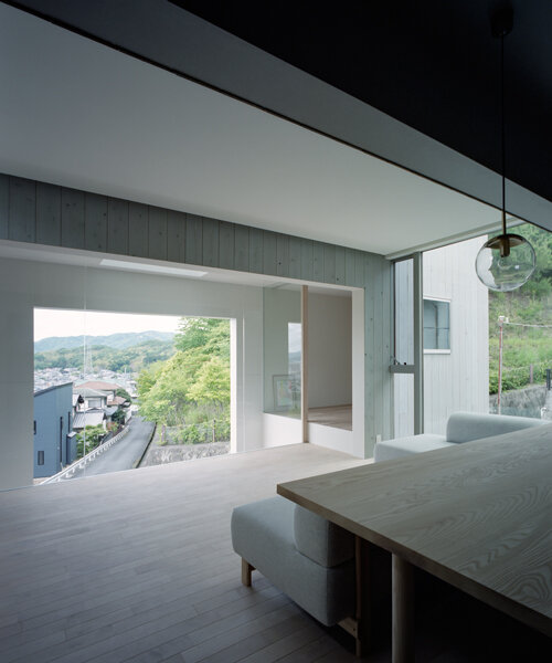 a picture frame window punctures house in himeji by fujiwaramuro architects in japan