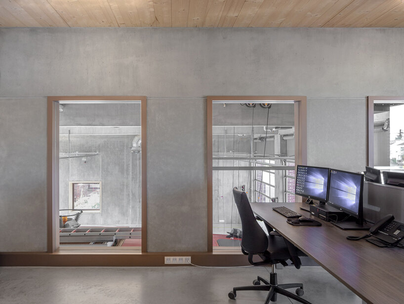 red façades + stacked volumes recall the function of this fire station in antwerp