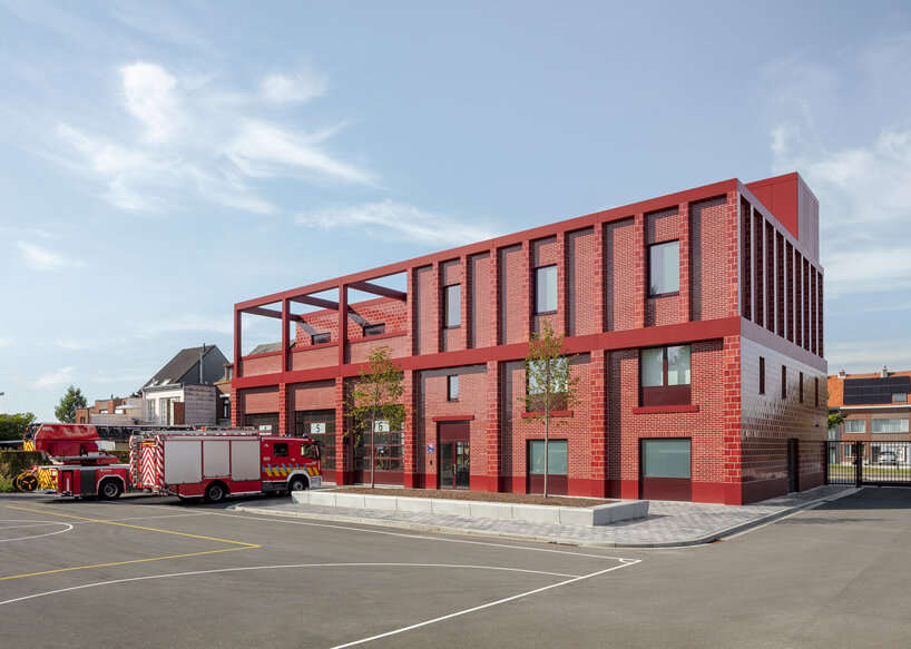 red façades + stacked volumes recall the function of this fire station in antwerp