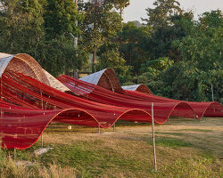 mpdstudio weaves fishing nets through the bamboo roof of 'theater cafe' in thailand