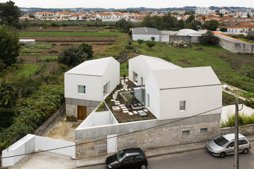 paulo merlini architects recovers derelict portuguese farmhouse with 'casa rio'