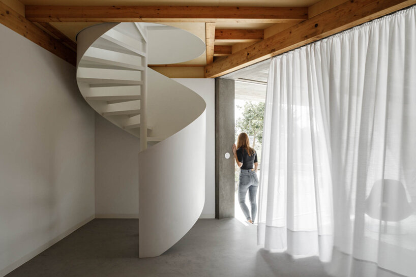 paulo merlini architects recovers derelict portuguese farmhouse with 'casa rio'