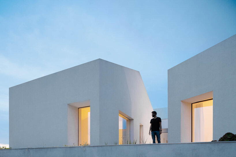 paulo merlini architects recovers derelict portuguese farmhouse with 'casa rio'