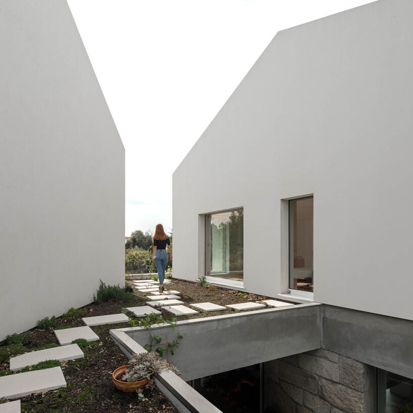 paulo merlini architects recovers derelict portuguese farmhouse with 'casa rio'