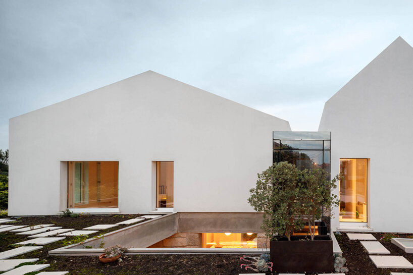 paulo merlini architects recovers derelict portuguese farmhouse with 'casa rio'