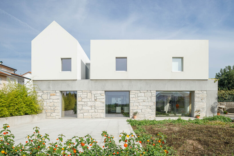 paulo merlini architects recovers derelict portuguese farmhouse with 'casa rio'