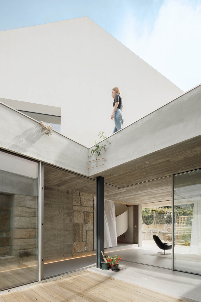 paulo merlini architects recovers derelict portuguese farmhouse with 'casa rio'