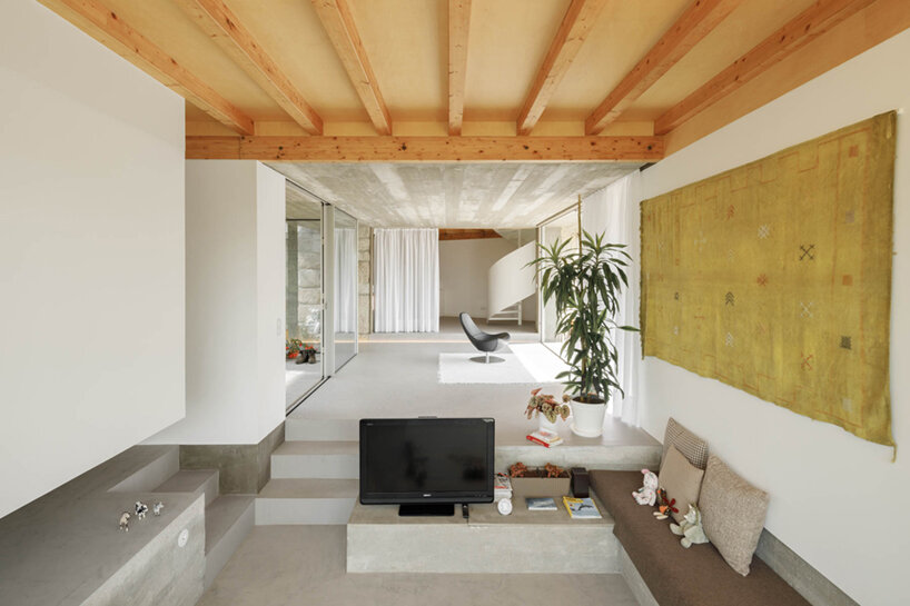 paulo merlini architects recovers derelict portuguese farmhouse with 'casa rio'