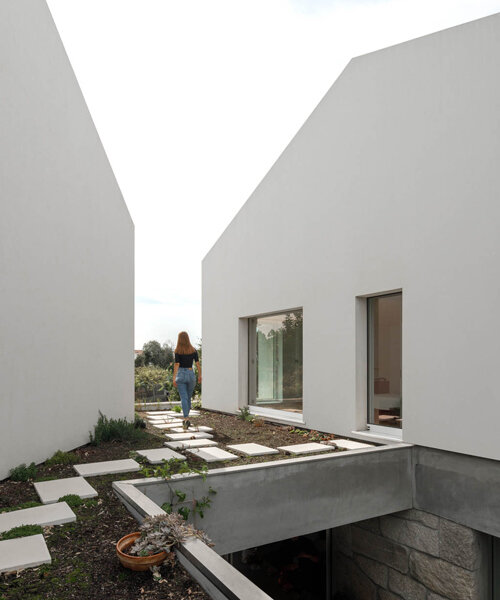 paulo merlini architects recovers derelict portuguese farmhouse with 'casa rio'