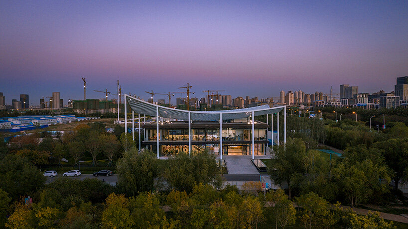 powerhouse company tops reception center for new city district in tianjin with 'paper roof'