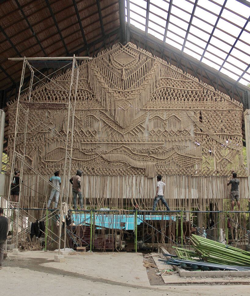 agnes hansella hangs massive macramé wall trio on a seaside structure in bali