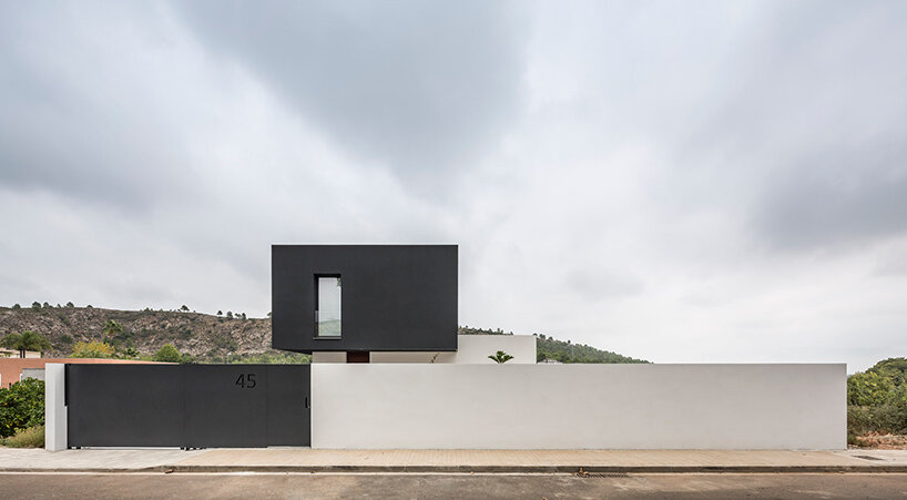 alberto facundo arquitectura assembles its catorce house as a stack of volumes in black and white