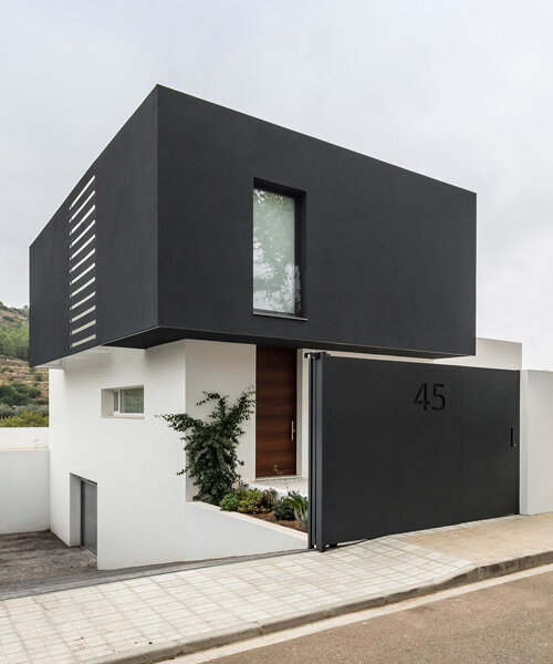 alberto facundo arquitectura assembles its catorce house as a stack of volumes in black and white