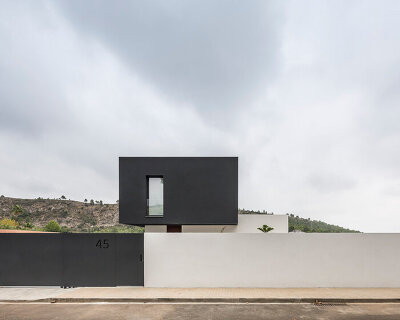 alberto facundo arquitectura assembles its catorce house as a stack of volumes in black and white