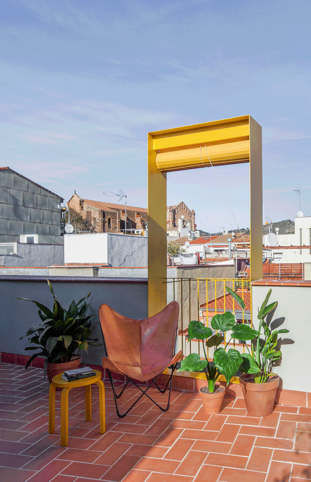 anna & eugeni bach punctuate 'seven lives' building in barcelona with yellow façade elements