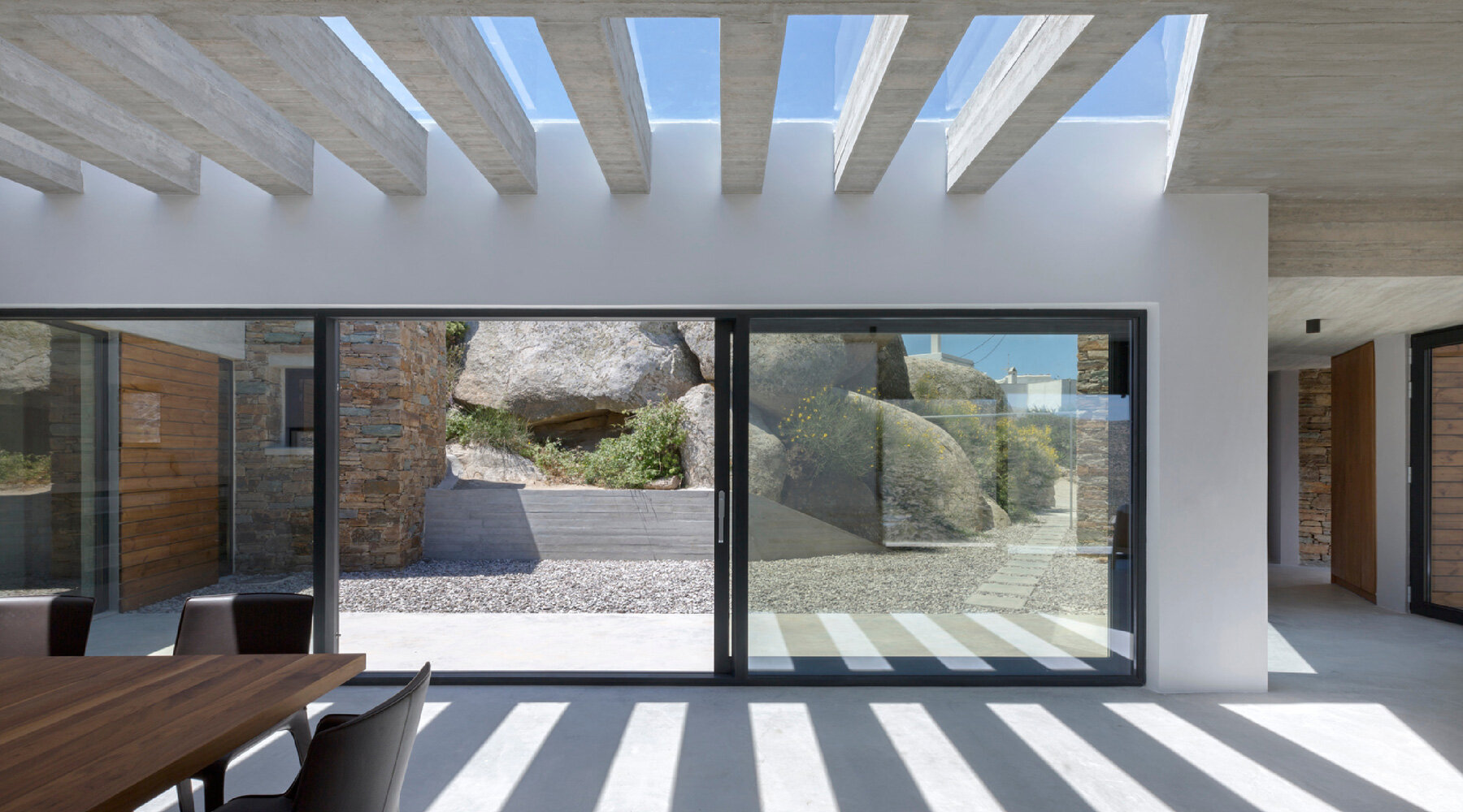 aristides dallas architects sets three-volume house between the rocks of tinos island