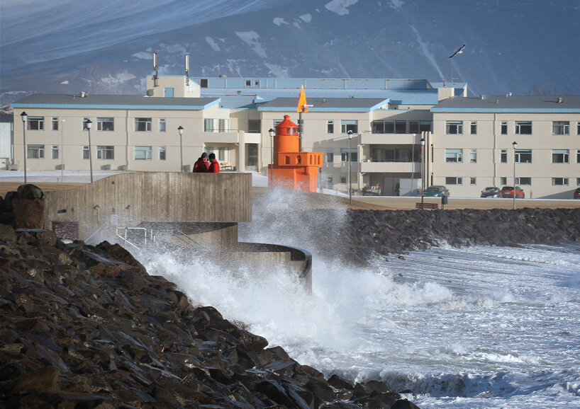 basalt architects nestles 'guðlaug baths' into a rocky breakwater barrier in iceland