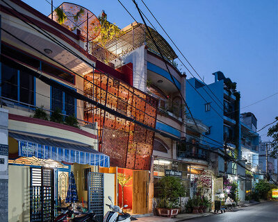 AD9 architects completes vietnamese house with perforated façade + sloped roof garden