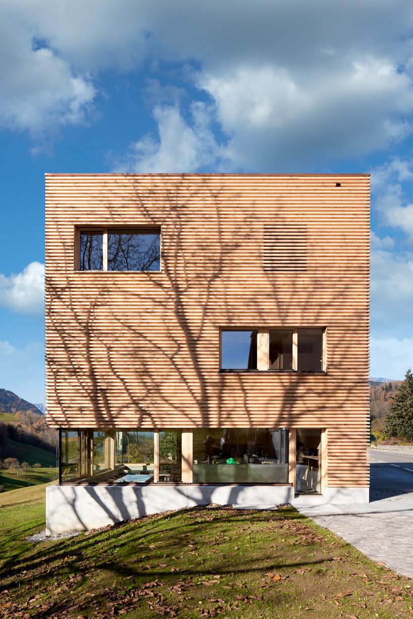 firm architekten builds cube house in austria using timber from the owner's private forest