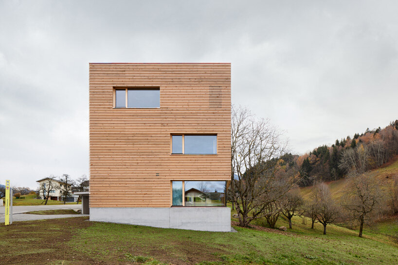 firm architekten builds cube house in austria using timber from the owner's private forest