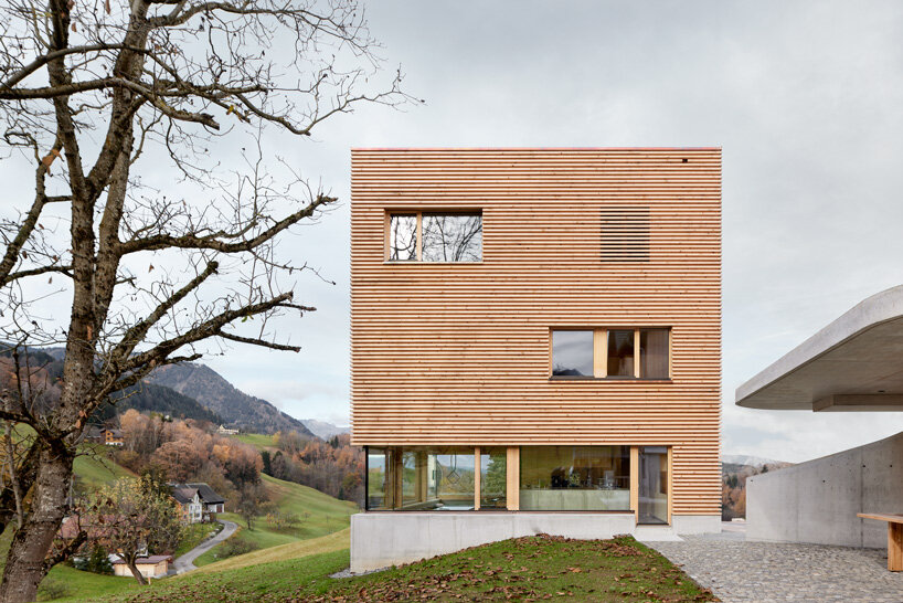 firm architekten builds cube house in austria using timber from the owner's private forest