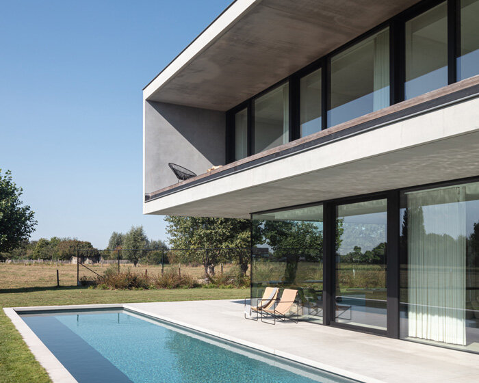 'residence DDE' by govaert & vanhoutte architects is a minimal concrete villa in rural belgium