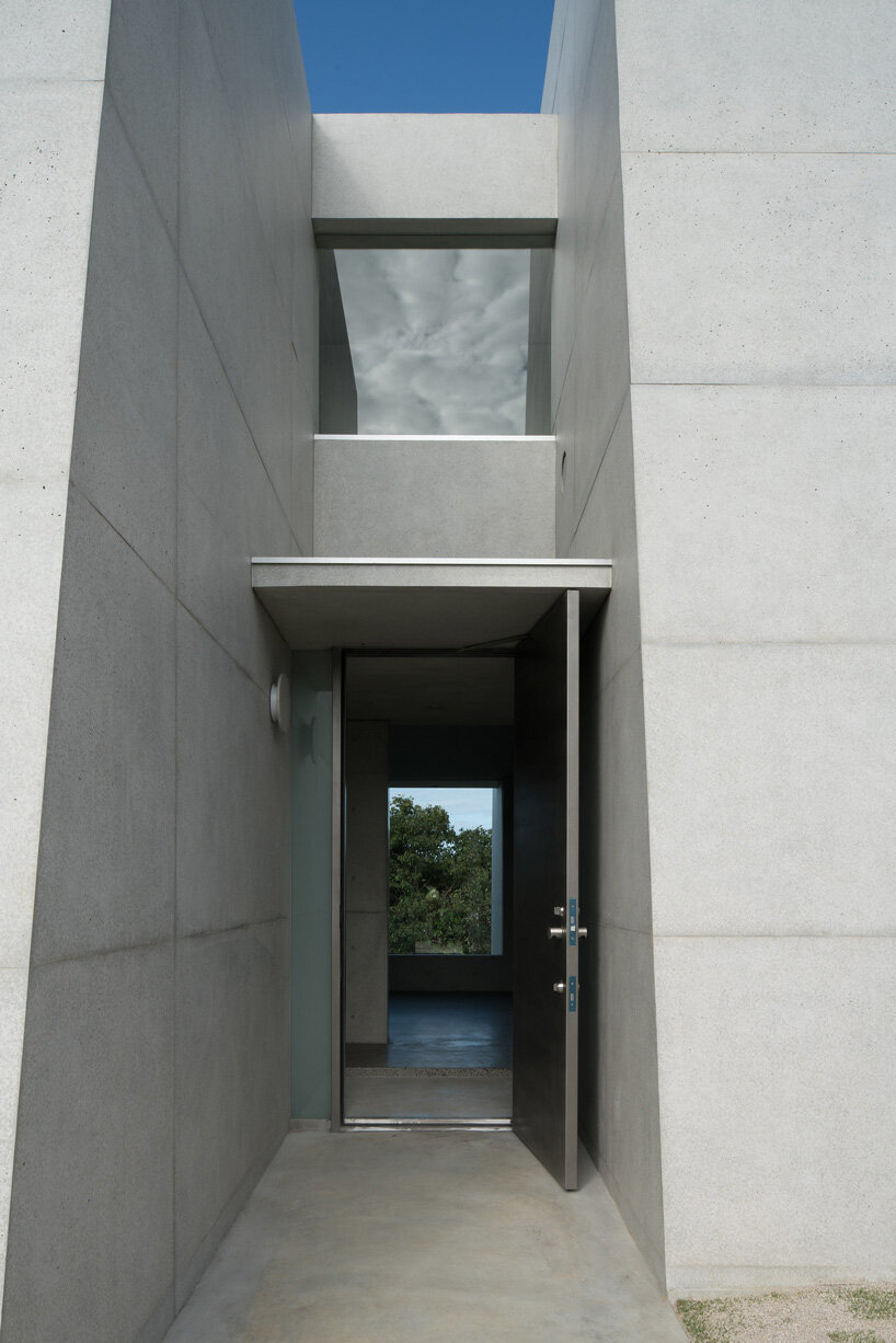 kazunori fujimoto architects builds fort-like house in japan with thick concrete exterior