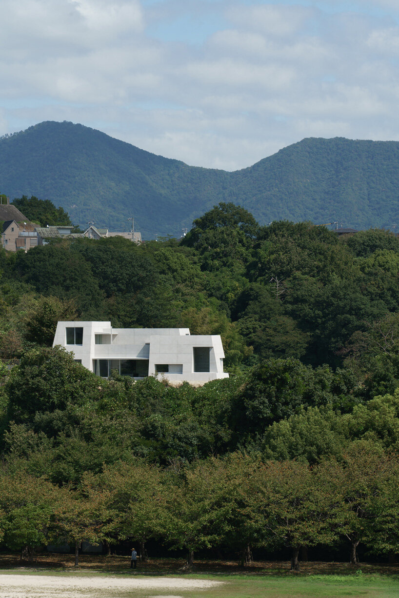 kazunori fujimoto architects builds fort-like house in japan with thick concrete exterior