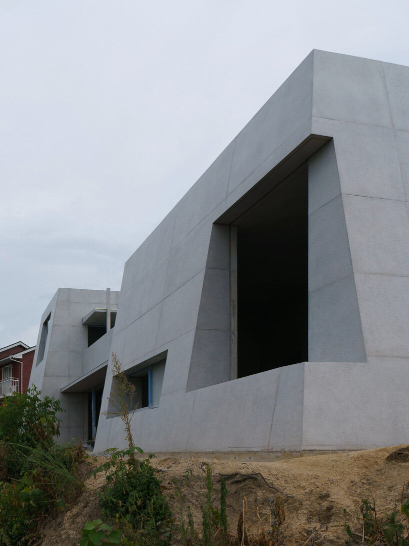 kazunori fujimoto architects builds fort-like house in japan with thick concrete exterior