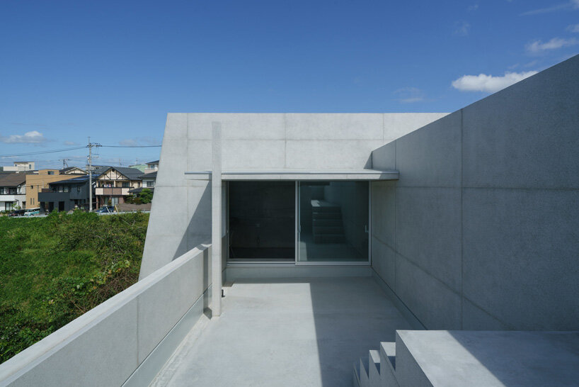 kazunori fujimoto architects builds fort-like house in japan with thick concrete exterior