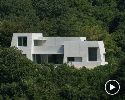 kazunori fujimoto architects builds fort-like house in japan with thick concrete exterior