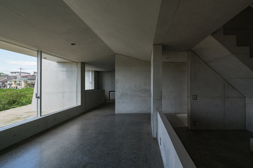 kazunori fujimoto architects builds fort-like house in japan with thick concrete exterior