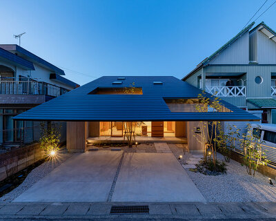 tatsuya kawamoto + associates encloses its imaise house with a broad, overhanging roof