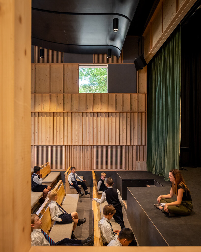 jonathan tuckey design completes red theater as part of school campus in south east england
